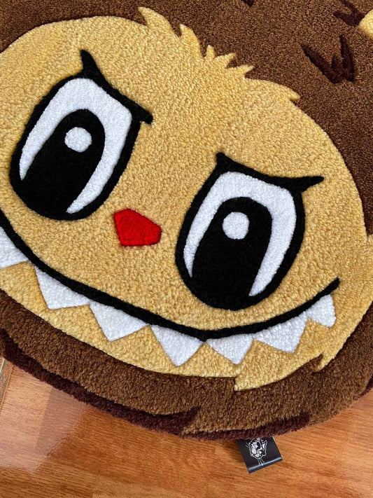 Labubu area rug close-up of yellow face, big blue-lined eyes, and red nose