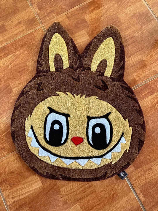 Labubu area rug with dark brown face, yellow eyes, and red nose