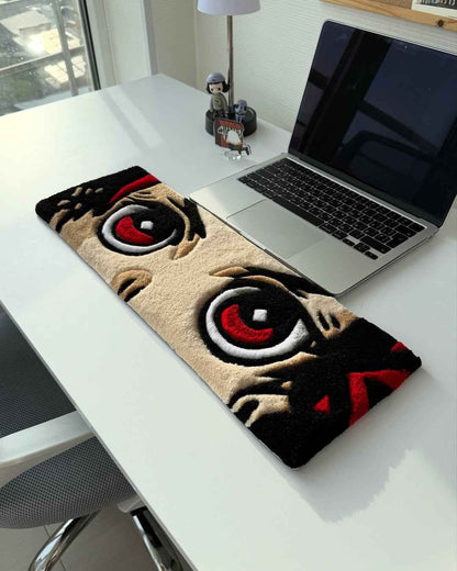 Handmade anime tufted desk mat with large red-and-black eye design on tan background