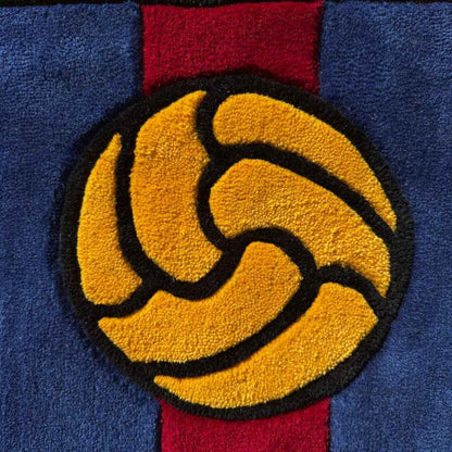 Plush rug close-up of gold emblem on blue and red shield crest