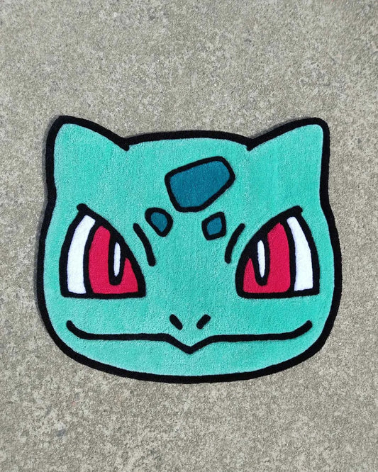 Bulbasaur head rug, turquoise face with red eyes and black outline border
