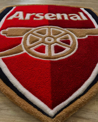 Arsenal crest football rug close-up with red shield, Arsenal text, and gold trim